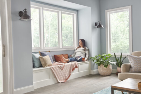 woman sitting next to window