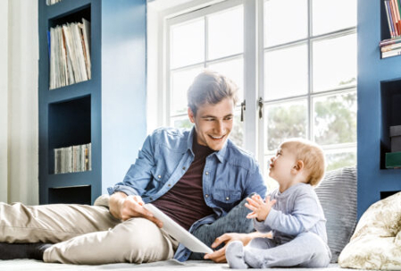 dad reading a book to his baby