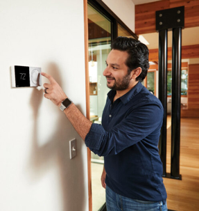 Man checking his thermostat